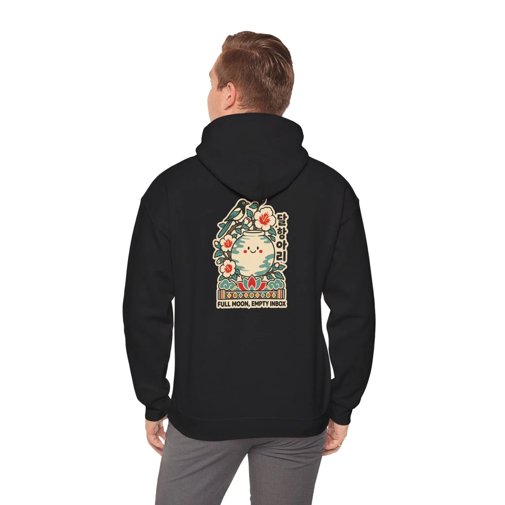 Back view of a black hoodie with a large graphic print, worn by a man