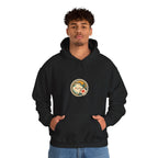 Man in a black hoodie with a round badge print on the chest