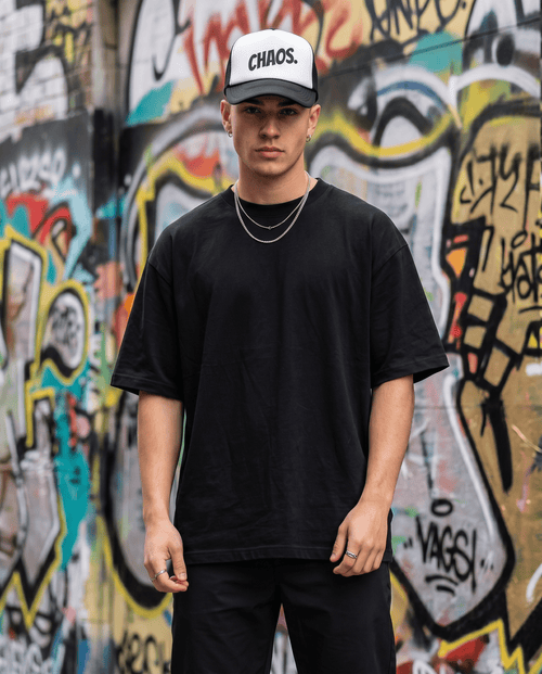 Model wearing CHAOS trucker hat, side angle