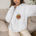 Woman on a sofa in an off-white hoodie with a small tteokbokki print