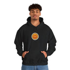 Man in a black hoodie with a small smiley face print on the chest