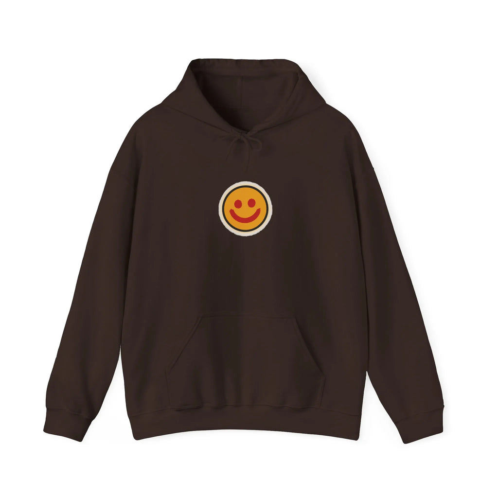 Front of a coffee brown hoodie with a small smiley face print