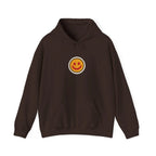 Front of a coffee brown hoodie with a small smiley face print