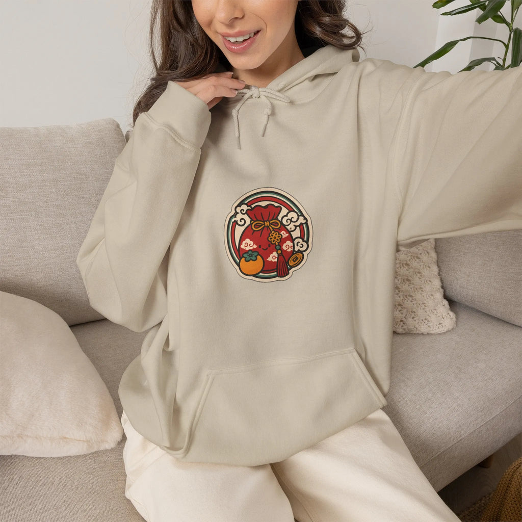 Woman relaxing on a sofa in a beige hoodie with a small lucky pouch badge