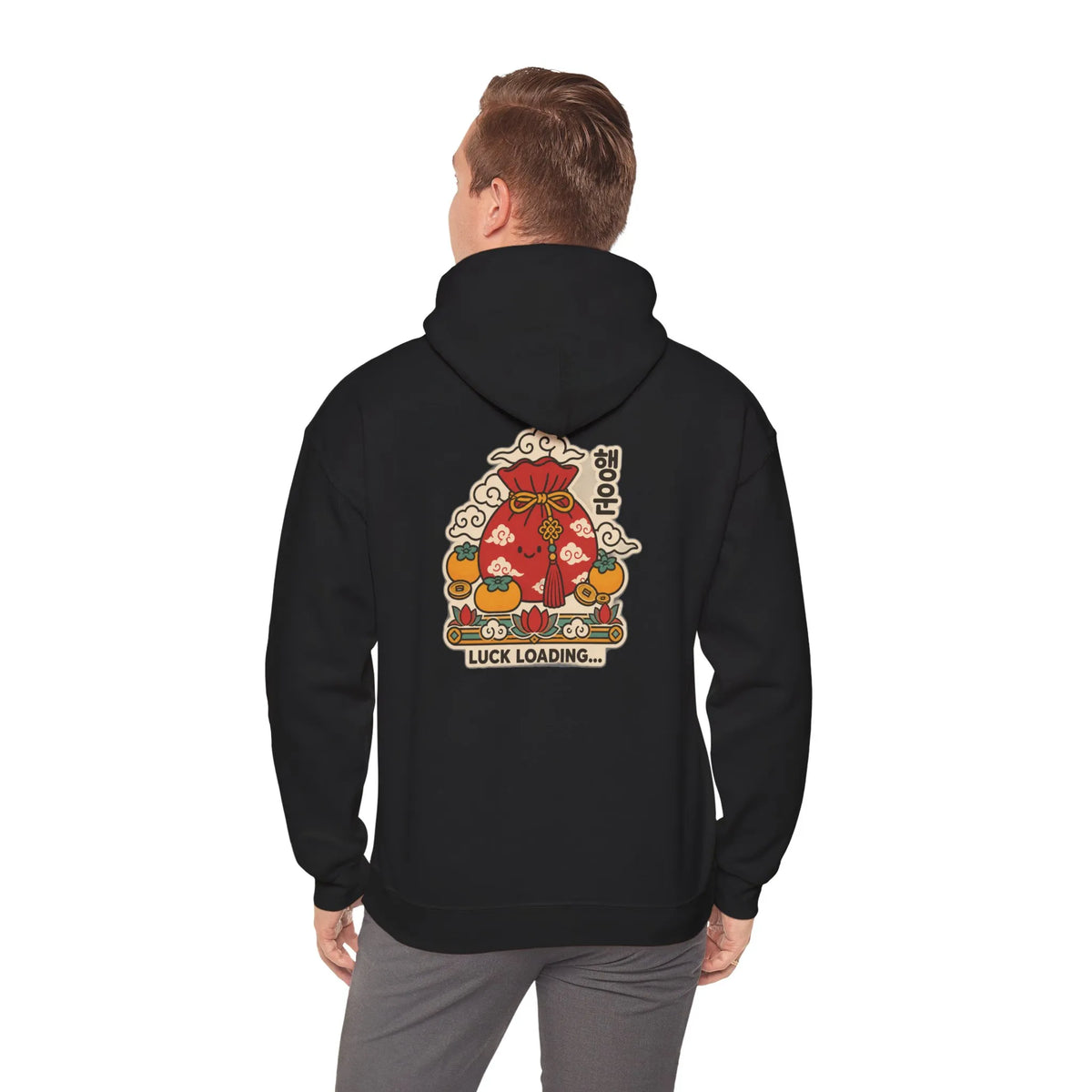 Back view of a black hoodie with a lucky pouch, persimmons and coins print, worn by a man
