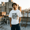 Model wearing "Main Character" Syndrome funky graphic tee, front view, rooftop