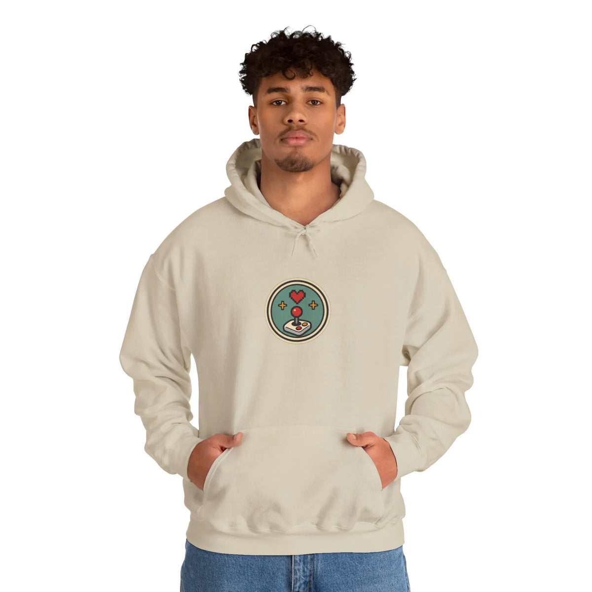 Man wearing a beige hoodie with a small round gaming badge on the chest