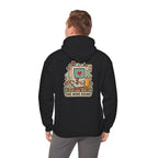 Back view of a black hoodie with a late-night gaming graphic, worn by a man
