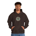 Man in a coffee brown hoodie with a small round gaming badge on the chest