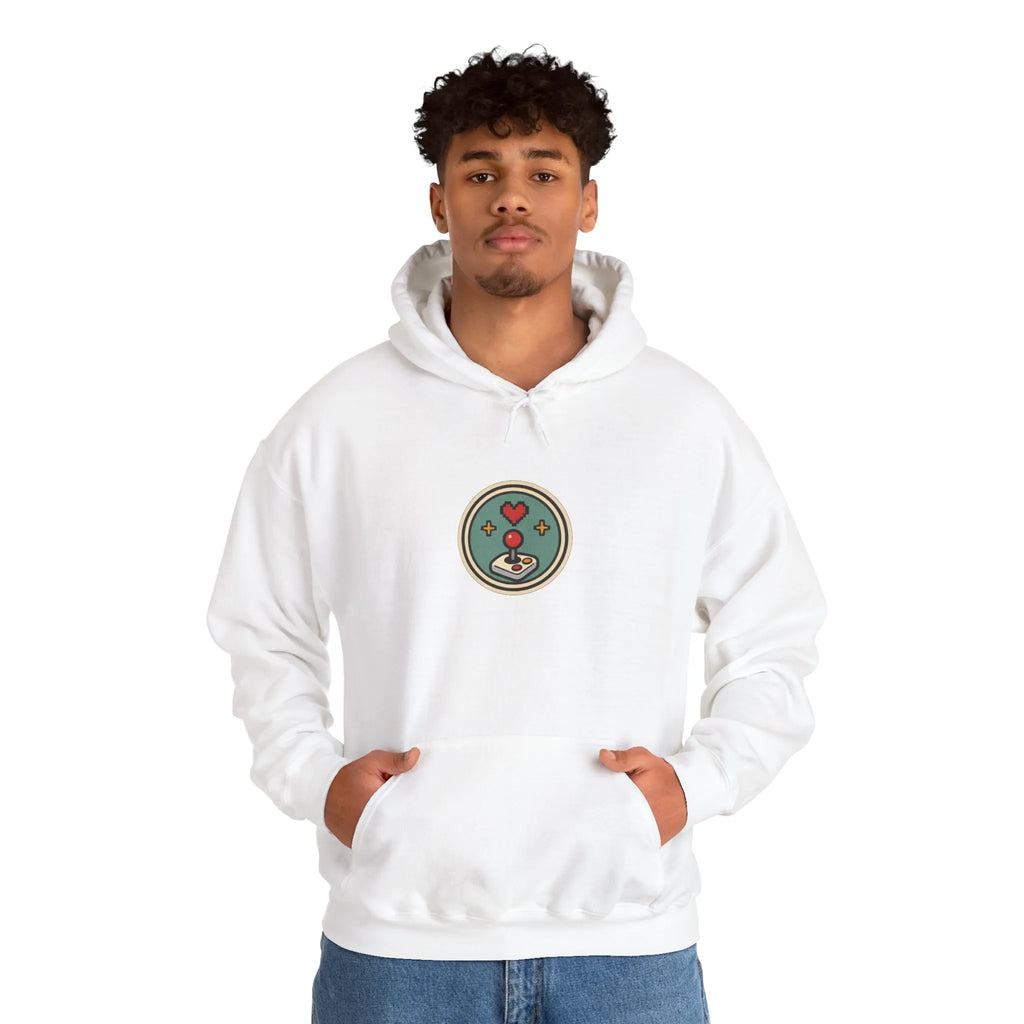 Man in an off-white hoodie with a small round gaming badge on the chest