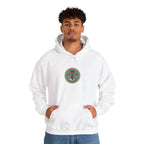 Man in an off-white hoodie with a small round gaming badge on the chest