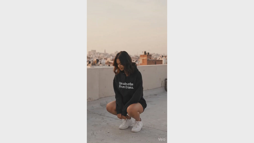 A girl showing off Unsubscribe Hoodie 