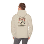 Back view of a beige hoodie with a varsity-style SEOUL athletic print, worn by a man