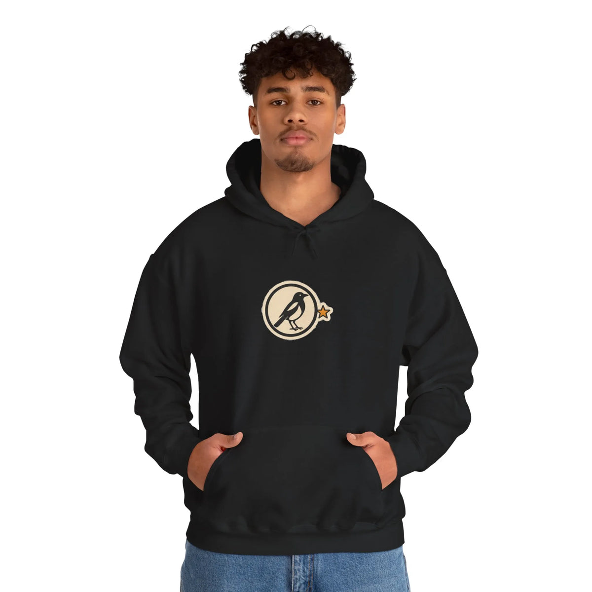 Man in a black hoodie with a small round athletic badge on the chest