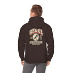 Back view of a coffee brown hoodie with a varsity-style SEOUL athletic print, worn by a man