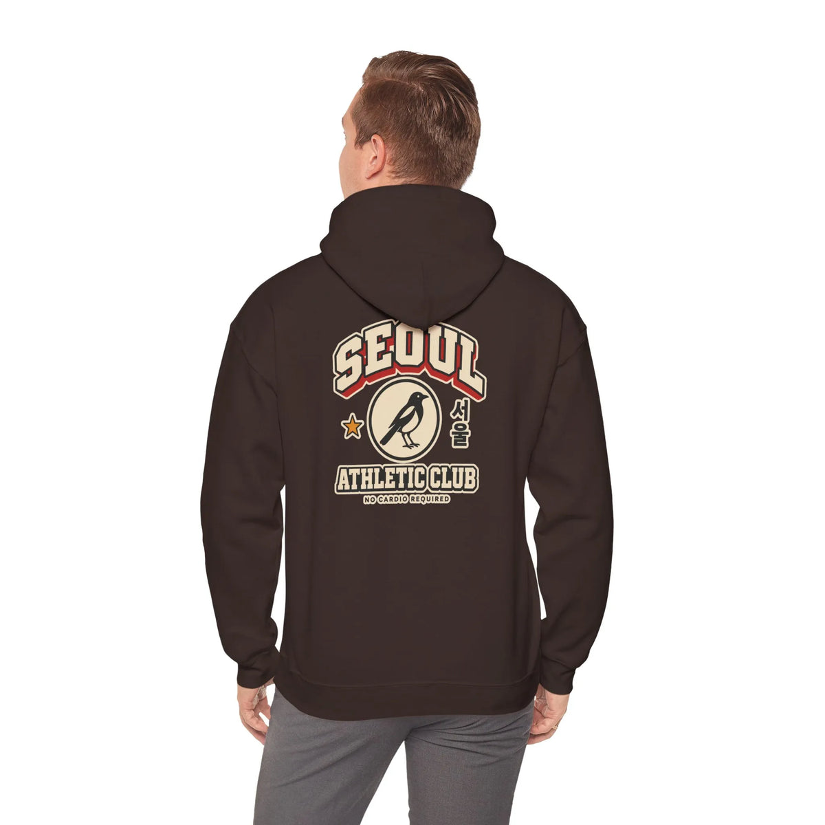 Back view of a coffee brown hoodie with a varsity-style SEOUL athletic print, worn by a man