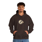 Man in a coffee brown hoodie with a small round athletic badge on the chest