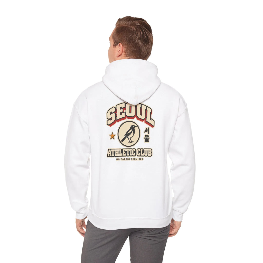 Back view of an off-white hoodie with a varsity-style SEOUL athletic print, worn by a man