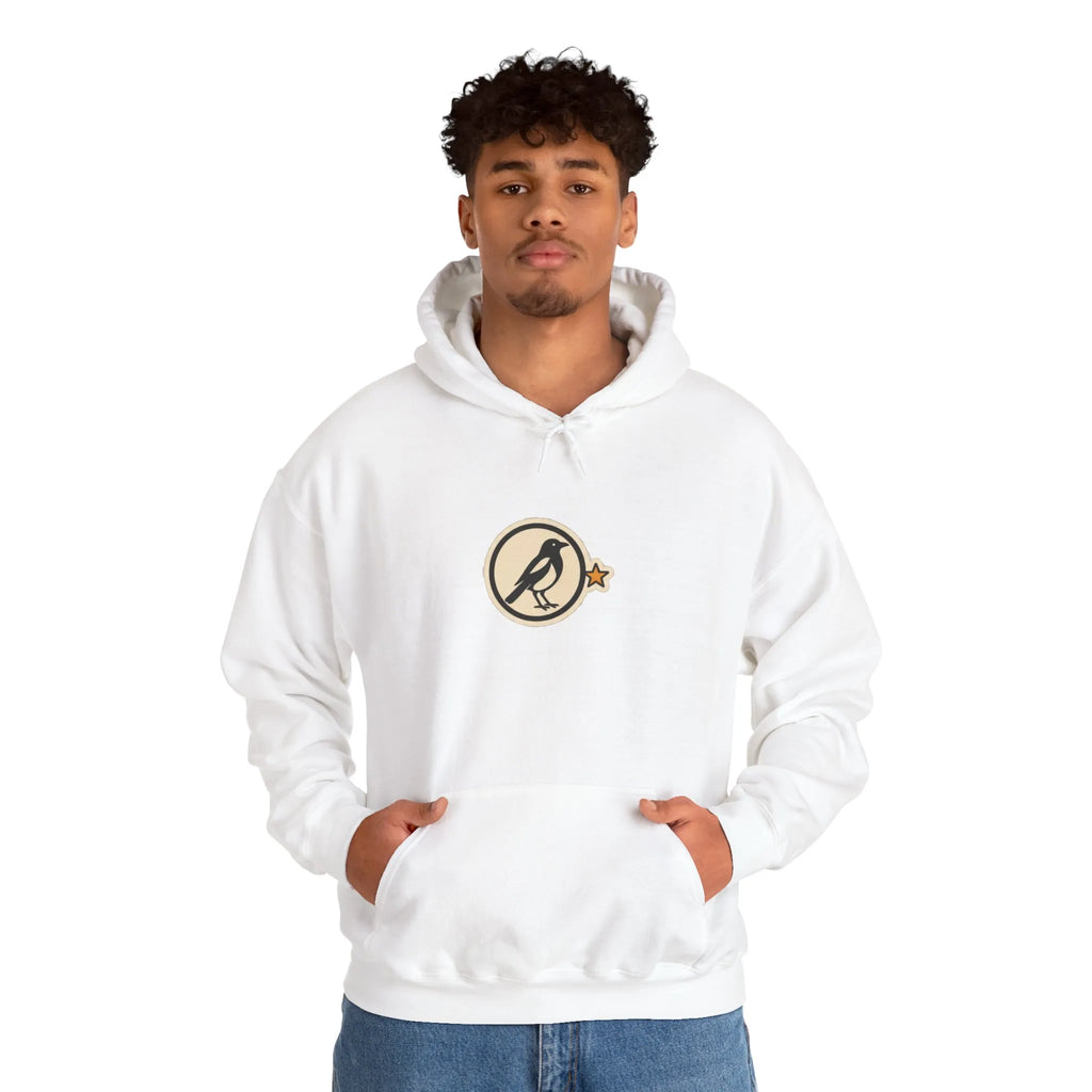 Man in an off-white hoodie with a small round athletic badge on the chest