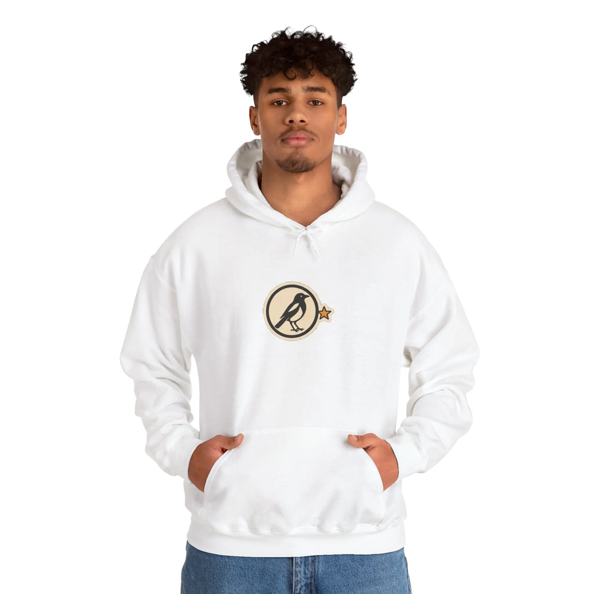 Man in an off-white hoodie with a small round athletic badge on the chest