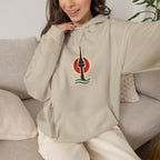Woman relaxing on a sofa in a beige hoodie with a small Seoul print