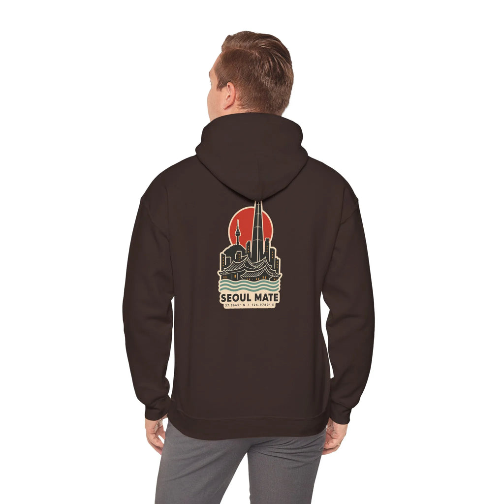 Back view of a coffee brown hoodie with a Seoul skyline and coordinates print, worn by a man