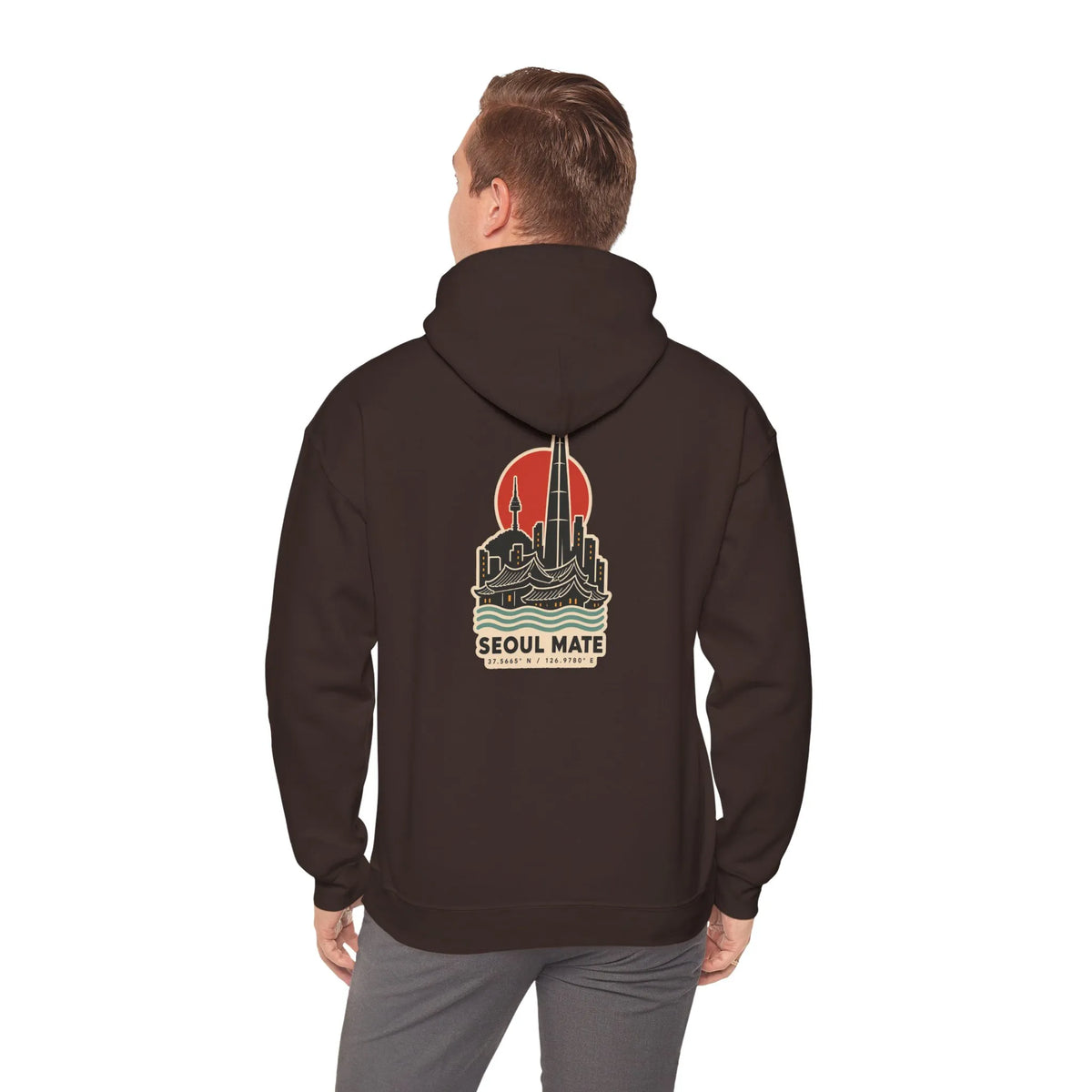 Back view of a coffee brown hoodie with a Seoul skyline and coordinates print, worn by a man