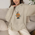Woman on a sofa in a beige hoodie with a small N Seoul Tower print