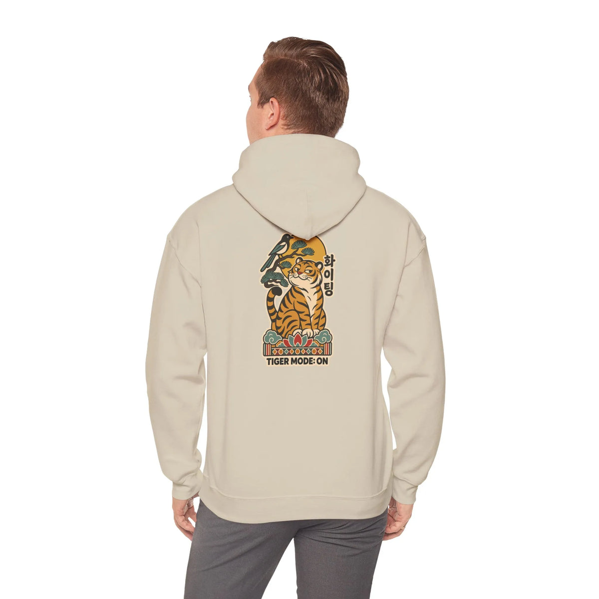 Back view of a beige hoodie with a tiger print, worn by a man