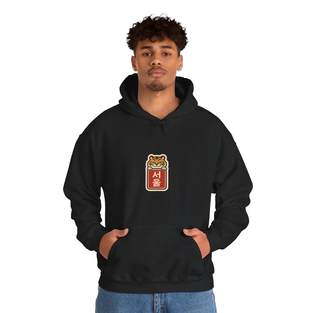 Man in a black hoodie with a small print on the chest