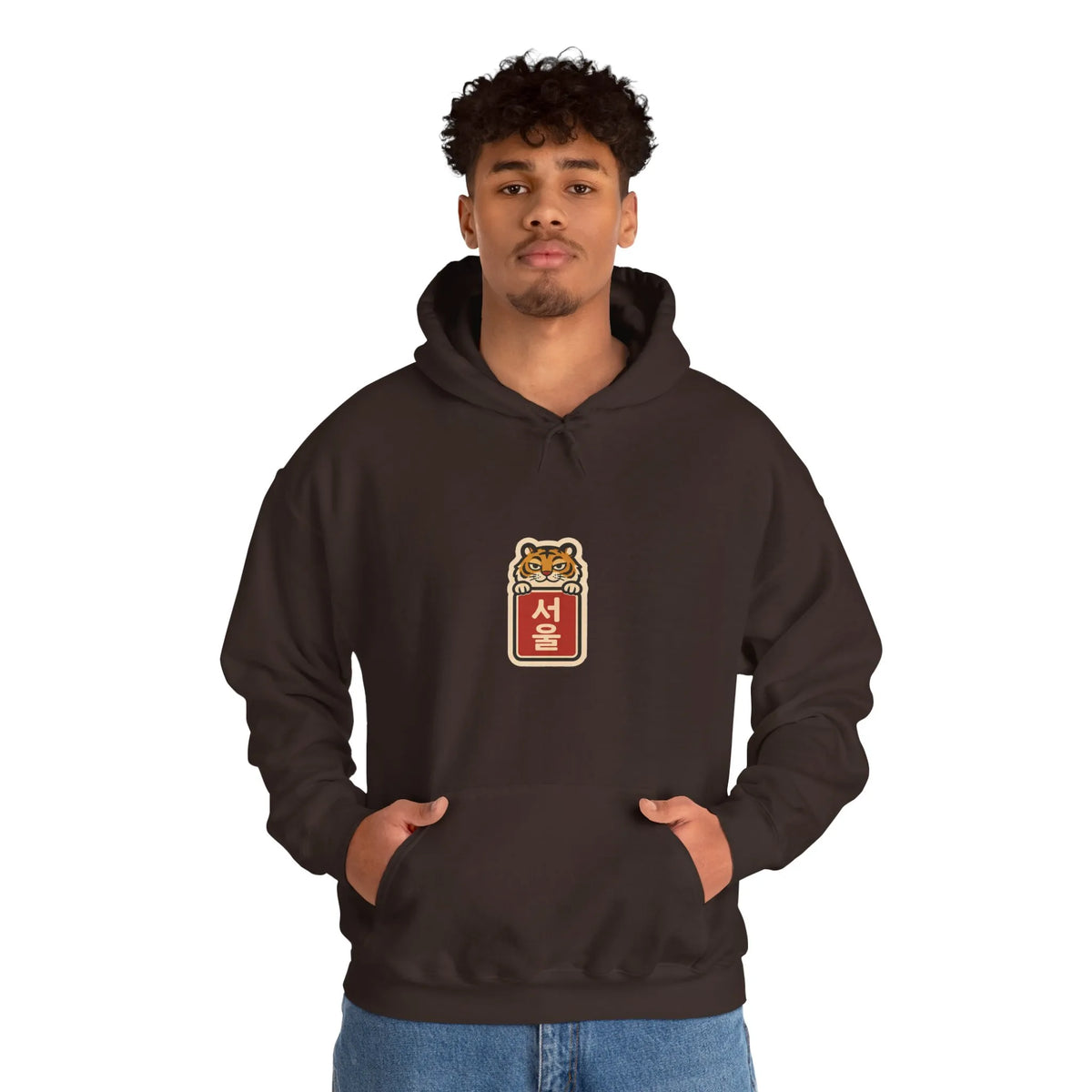 Man in a coffee brown hoodie with a small chest print