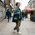 Model carrying Wear Pardesi streetwear tote bag, street style